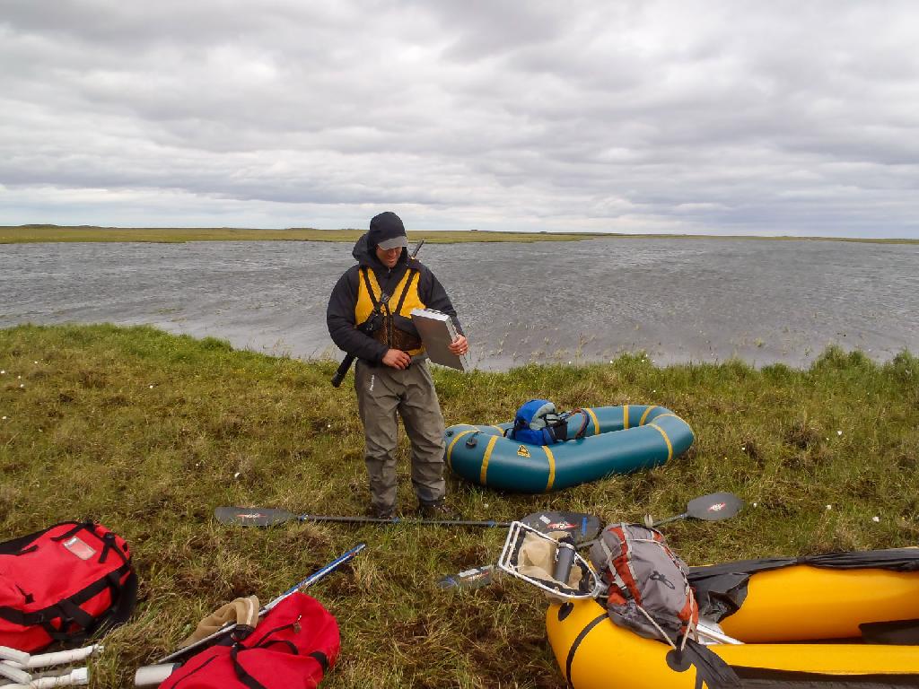 ecologist packing gear at lake